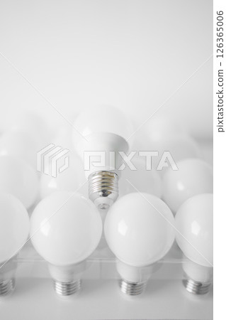 round white LED light bulb. many modern light bulbs on a white table round white LED light bulb. many modern light bulbs on a white table 126365006
