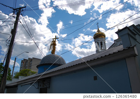 Church domes against the sky. Church sculptures and golden domes against the backdrop of the heaven. 126365480