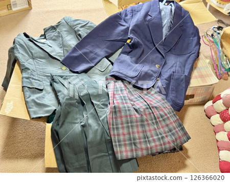 Schoolgirl uniforms spread out during decluttering 126366020