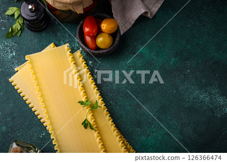 Uncooked lasagna pasta with cooking ingredient Uncooked lasagna pasta with cooking ingredient 126366474