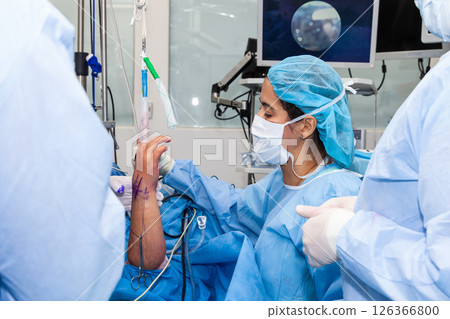 Female doctor performing a surgery. Orthopedic surgeon. Surgery and insurance concept. 126366800