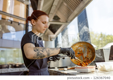 A skilled chef creates delicious dishes in a modern kitchen full of creativity and artistry A skilled chef creates delicious dishes in a modern kitchen full of creativity and artistry 126367040