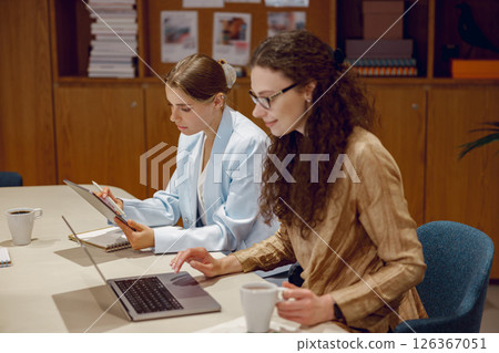 Business Women Collaborating Effectively in a Contemporary Office Environment Setting Business Women Collaborating Effectively in a Contemporary Office Environment Setting 126367051