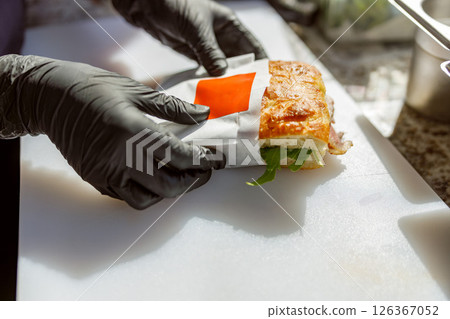A Freshly Wrapped Sandwich Filled with a Variety of Colorful Ingredients and Flavors A Freshly Wrapped Sandwich Filled with a Variety of Colorful Ingredients and Flavors 126367052