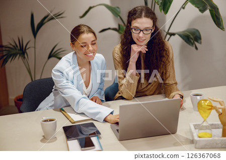 Engaging in a Collaborative Business Meeting While Using Laptops and Enjoying Coffee Engaging in a Collaborative Business Meeting While Using Laptops and Enjoying Coffee 126367068