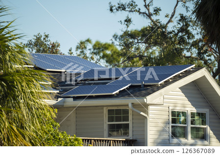 Private home roof covered with solar photovoltaic panels for generating of clean ecological electric energy in suburban rural town area. Concept of autonomous house 126367089