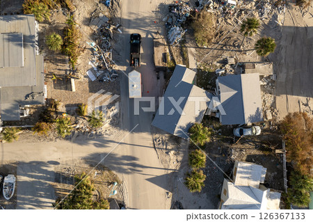 Piles of garbage from severely damaged homes after hurricane Milton storm surge in Florida. Debris on street side on Manasota Key in Englewood. Hurricane aftermath cleanup 126367133