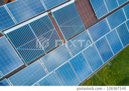 Photovoltaic panels and vacuum air solar collectors for water heating and producing of clean electricity mounted on house rooftop. Production of renewable electric and heat energy with zero emission Photovoltaic panels and vacuum air solar collectors for water heating and producing of clean electricity mounted on house rooftop. Production of renewable electric and heat energy with zero emission 126367140
