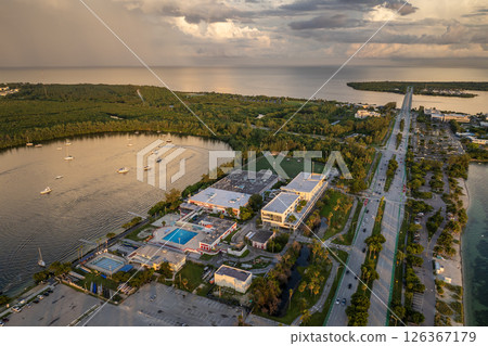 Miami, Florida. Fishing and recreational yachts and boats sailing in Biscayne Bay harbor. Sunset over city skyline with high-rise buildings in downtown 126367179