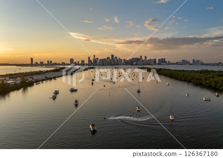 Miami, Florida. Biscayne Bay harbor near Virginia Key with yachts and sailboats at sunset. Urban skyline with high-rise buildings in downtown 126367180
