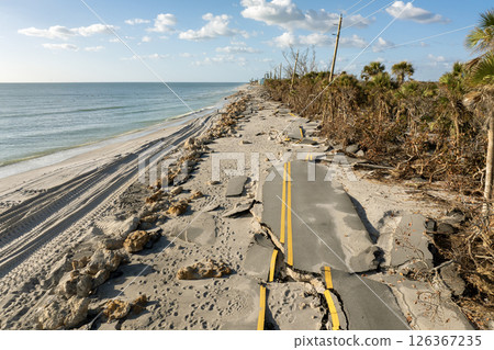 Hurricane storm surge destroyed waterfront road on ocean shore in Florida. Severe damage to transportation infrastructure 126367235