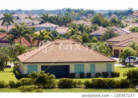 Hurricane shutters made from steel mounted for protection of house windows. Protective measures before natural disaster in Florida 126367237