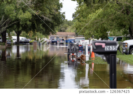 Hurricane flooded street with mail box surrounded with water in Florida residential area. Consequences of natural disaster Hurricane flooded street with mail box surrounded with water in Florida residential area. Consequences of natural disaster 126367425