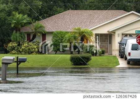 Hurricane flooded street with mail box surrounded with water in Florida residential area. Consequences of natural disaster 126367426