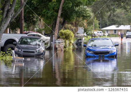 Hurricane Debby flooded city street with trapped cars submerged under water in Florida residential area. Consequences of natural disaster Hurricane Debby flooded city street with trapped cars submerged under water in Florida residential area. Consequences of natural disaster 126367431