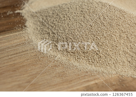 Dry yeast scattered on wooden surface, copy place for text. 126367455