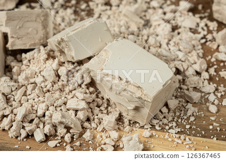 Compressed fresh yeast cubes close-up on a wooden background. Compressed fresh yeast cubes close-up on a wooden background. 126367465