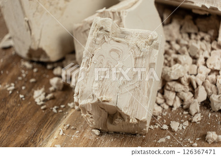 Compressed fresh yeast cubes close-up on a wooden background. Compressed fresh yeast cubes close-up on a wooden background. 126367471