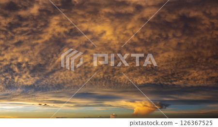Getting dark at sundown. Sunset sky with scattered clouds of bright colors 126367525