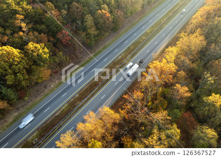 Freeway road with fast moving traffic cars and trucks in North Carolina Appalachian mountains in fall season. Interstate transportation infrastructure in USA 126367527