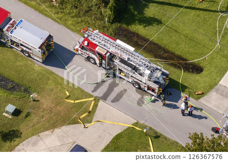 First responders investigating fire hazard of private house. Emergency service personnel responding to carbon monoxide accident on Florida residential street First responders investigating fire hazard of private house. Emergency service personnel responding to carbon monoxide accident on Florida residential street 126367576