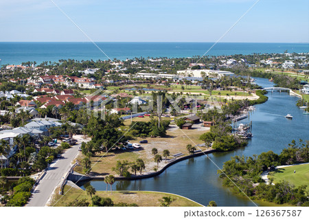 Expensive waterfront houses between green palm trees in Boca Grande, small town on Gasparilla Island in southwest Florida. Premium housing development in the USA 126367587