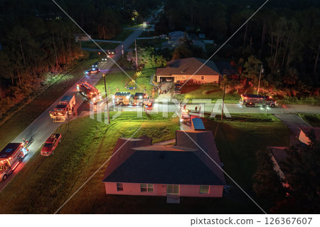 Emergency service personnel responding to potential fire hazard at Florida home. First responders ready to extinguish fire of burning house 126367607