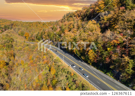 Elevated view of freeway road lanes between autumn mountain hills. Interstate transportation infrastructure in USA 126367611