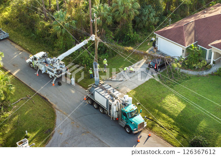 Electricity outage fixing after hurricane in Florida. Electrician workers repairing damaged power lines Electricity outage fixing after hurricane in Florida. Electrician workers repairing damaged power lines 126367612