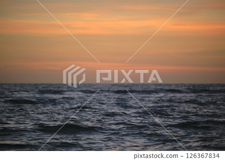 Dramatic red ocean waves at sunset with soft evening sea dark water 126367834