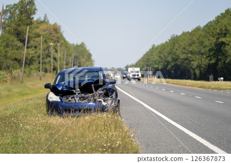 Crashed car damaged in traffic accident parked on road side. Abandoned broken vehicle Crashed car damaged in traffic accident parked on road side. Abandoned broken vehicle 126367873