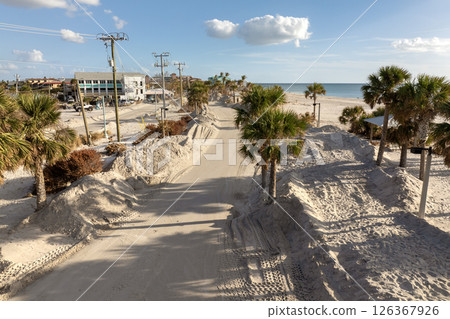 Consequences of natural disaster. Trash from severely damaged houses after hurricane Milton storm surge. Piles of debris on street side on Manasota key street in Florida 126367926