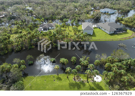 Consequences of natural disaster. Heavy flood with high water surrounding residential houses after hurricane Ian rainfall in Florida residential area Consequences of natural disaster. Heavy flood with high water surrounding residential houses after hurricane Ian rainfall in Florida residential area 126367929