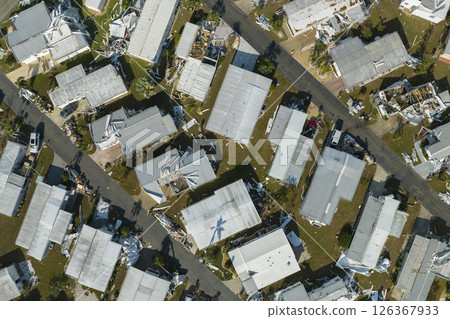 Consequences of natural disaster in Florida, USA. Aerial view of heavily damaged by hurricane Ian houses in mobile home residential area 126367933
