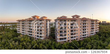 Condo building in Florida rural wooded area with view at tropical nature. Real estate development in American suburbs Condo building in Florida rural wooded area with view at tropical nature. Real estate development in American suburbs 126367934