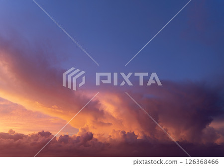 Bright sunset with setting sun behind vivid orange and yellow clouds 126368466