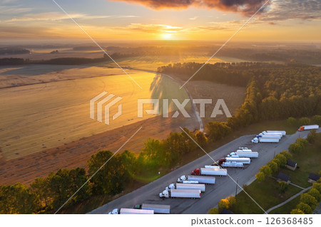 Big parking truck stop for tractor trailers rest area near busy American highway. Hauling cargo concept 126368485