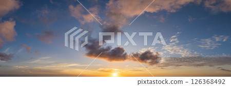 Beautiful sunset sky scenery. Bright colorful orange and yellow clouds on horizon 126368492