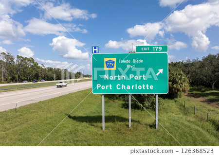 American interstate highway directional exit sign on fast motorway in Florida, USA. I-75 freeway junction leading to North Port and Port Charlotte 126368523