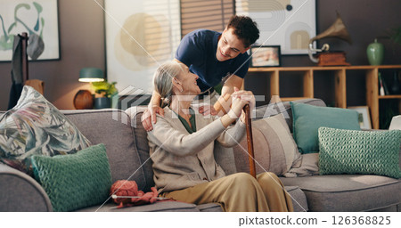 Senior woman, nurse and sofa with assisted living for healthcare service at old age home. Caregiver, medical worker or physiotherapist helping elderly or person with a disability at retirement house 126368825