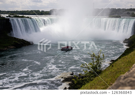 Tour Boat Navigating the Misty Waters of Niagara Falls Horseshoe Falls 126368843