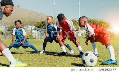Coach, black kids and stretching for soccer practice of fitness training, exercise and sports workout. Children, warm up and preparation for game, learning skills and team challenge of match activity Coach, black kids and stretching for soccer practice of fitness training, exercise and sports workout. Children, warm up and preparation for game, learning skills and team challenge of match activity 126368877