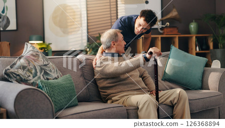 Senior man, nurse and sofa with assisted living for healthcare service at old age home. Caregiver, medical worker or physiotherapist helping elderly or person with a disability at retirement house 126368894