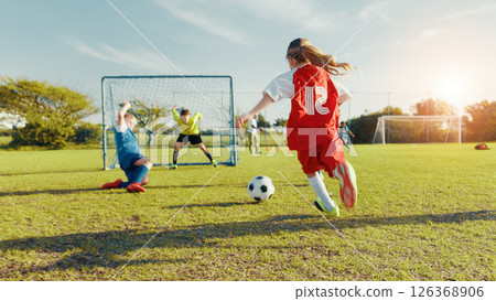 Sports field, kick and soccer player with skills, children and athlete with energy for match and cardio. Playing, football and kids with sportswear for game, growth and development of girl or back Sports field, kick and soccer player with skills, children and athlete with energy for match and cardio. Playing, football and kids with sportswear for game, growth and development of girl or back 126368906
