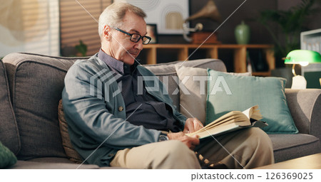 Senior man, reading book and relax on couch with study, literature and fiction in lounge at apartment. Elderly person, novel and knowledge on sofa with language, info or storytelling in living room Senior man, reading book and relax on couch with study, literature and fiction in lounge at apartment. Elderly person, novel and knowledge on sofa with language, info or storytelling in living room 126369025