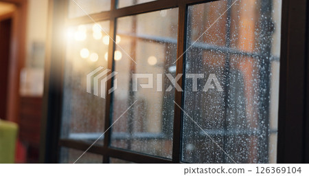 Frame, window and glass with rain in home for wet weather, cold season and winter. Aesthetic, background and closeup of pane with view of water droplets, moisture and condensation for calm in house 126369104