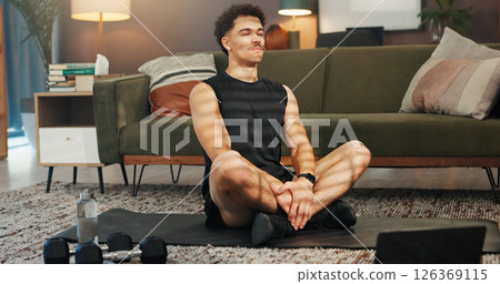 Man, fitness and laptop on floor in home with video tutorial for exercise, training and learning in lounge. Person, computer and online class on internet, workout and equipment on mat at apartment 126369115