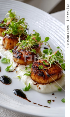Gourmet seared scallops with microgreens and balsamic glaze on puree. 126369158