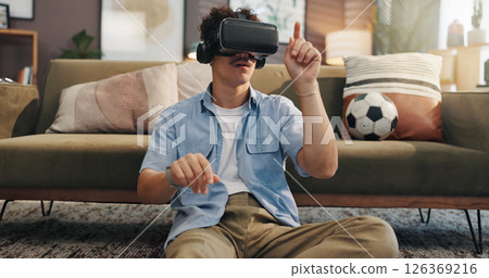 Futuristic, video games and man with vr headset, sofa or online for virtual reality in lounge or app. Esports, gamer and person with tech for entertainment, player or subscription for fantasy in home 126369216