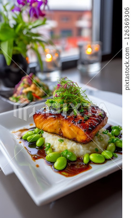 Grilled salmon with edamame and rice garnished with microgreens. 126369306